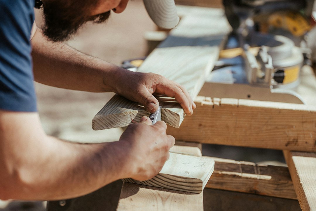 contact-img a-man-working-on-a-piece-of-wood-o8c5sxncgaw